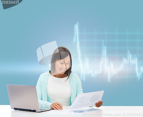 Image of asian businesswoman with laptop and documents