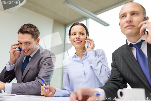 Image of business team with smartphones having conversation