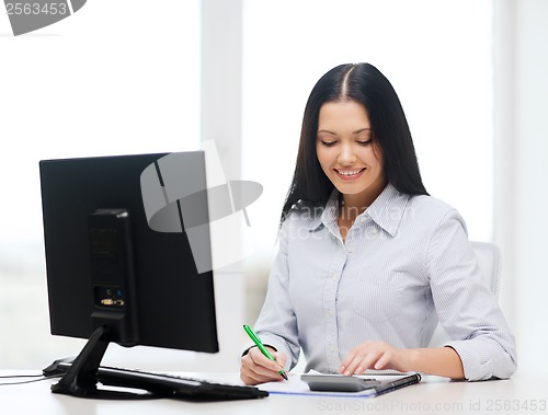 Image of businesswoman or student working with calculator