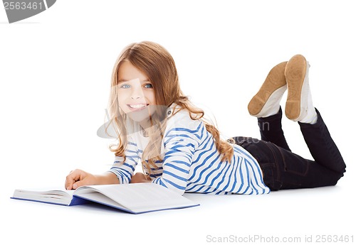 Image of smiling little student girl lying on the floor