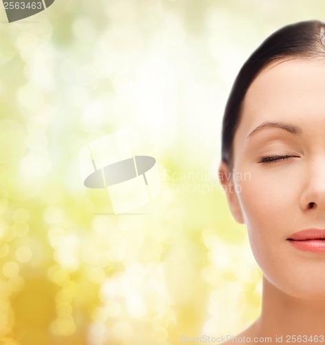 Image of relaxed young woman with closed eyes