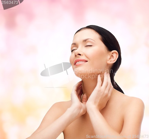 Image of smiling young woman with closed eyes