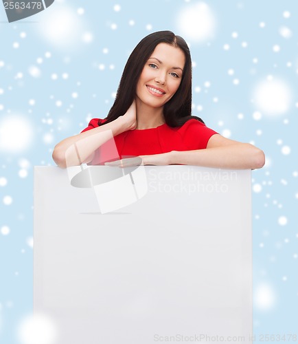 Image of smiling young woman with blank white board