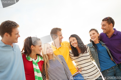 Image of group of friends having fun on the beach