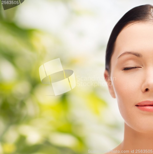 Image of relaxed young woman with closed eyes