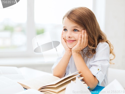 Image of student girl writing in notebook at school
