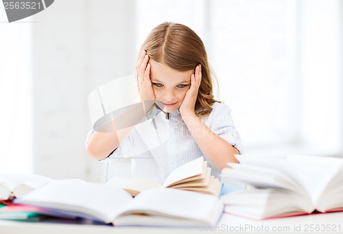 Image of pretty girl with many books at school