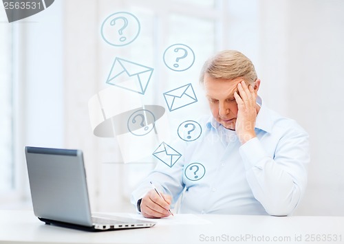 Image of old man filling a form at home