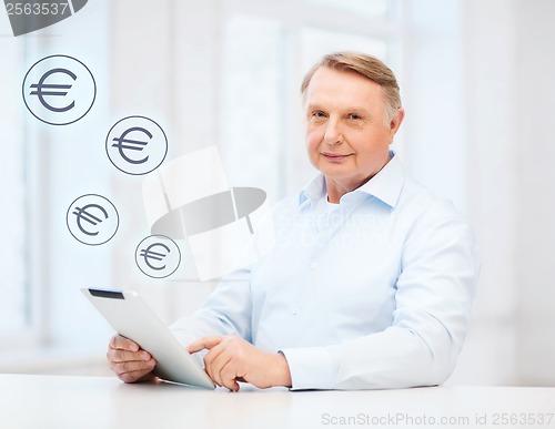 Image of old man with tablet computer at home