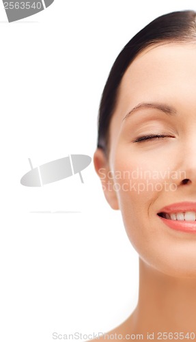 Image of smiling young woman with closed eyes
