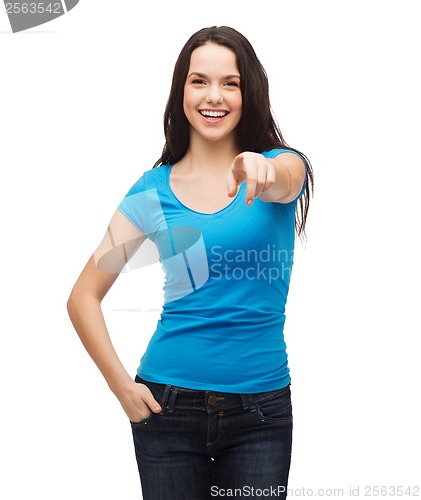 Image of happy girl in blank blue t-shirt pointing at you