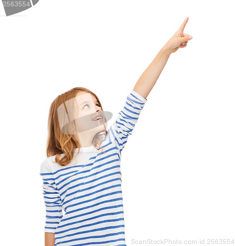 Image of smiling girl pointing at virtual screen