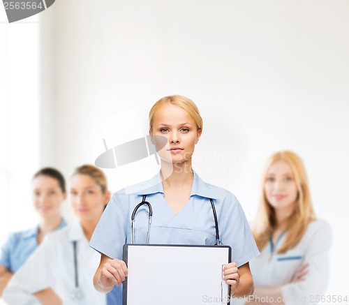 Image of smiling female doctor or nurse with sclipboard