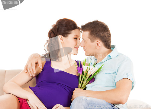 Image of happy expecting parents at home