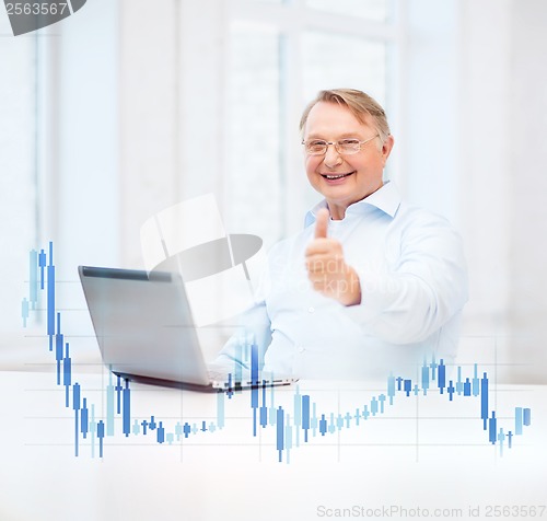 Image of old man with laptop computer showing thumbs up