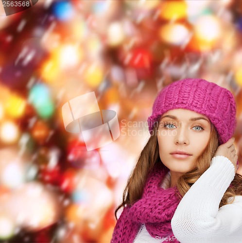 Image of woman in pink hat and scarf