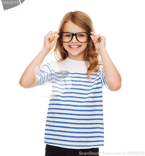 Image of smiling cute little girl with black eyeglasses