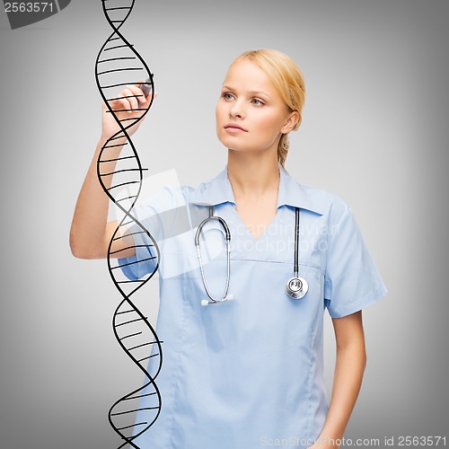 Image of focused doctor or nurse drawing dna molecule