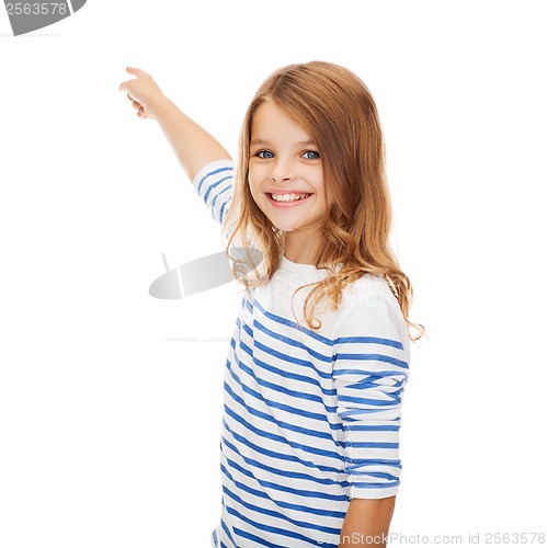 Image of smiling girl pointing at virtual screen