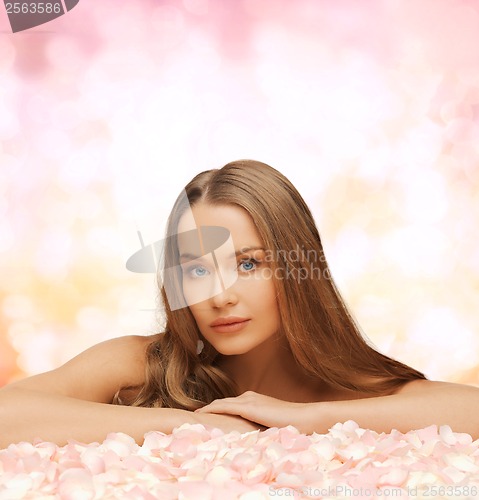 Image of woman with long hair and rose petals