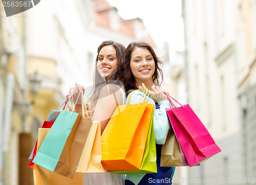 Image of beautiful women with shopping bags in the ctiy