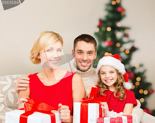 Image of smiling family holding many gift boxes