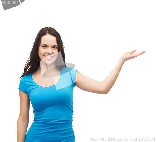 Image of teenager holding something on the palm of her hand