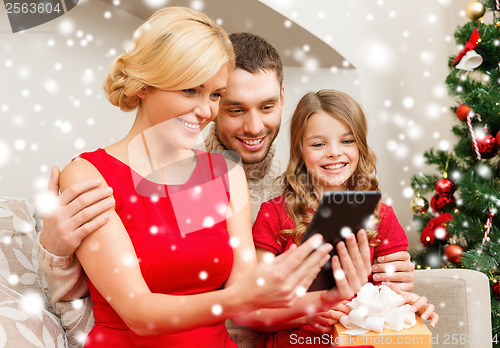 Image of smiling family with tablet pc