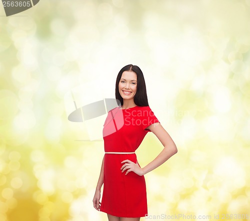 Image of smiling young woman in red dress