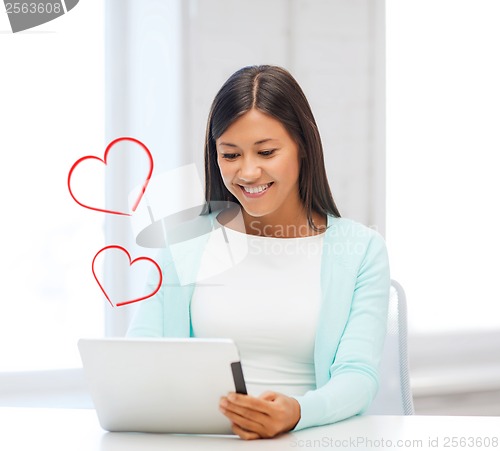 Image of smiling woman with tablet pc