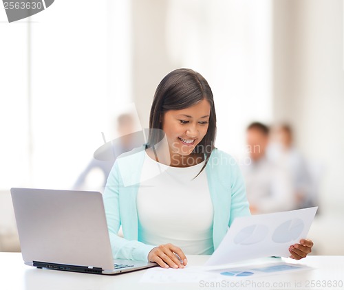 Image of asian businesswoman with laptop and documents