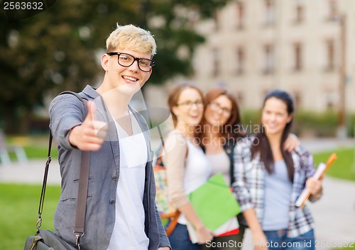 Image of male student in eyglasses showing thumbs up