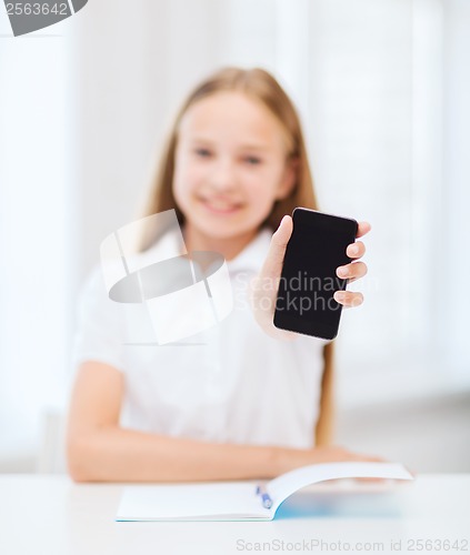 Image of smiling student girl with smartphone at school