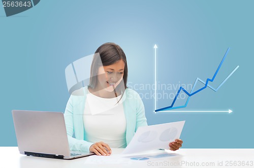 Image of asian businesswoman with laptop and documents