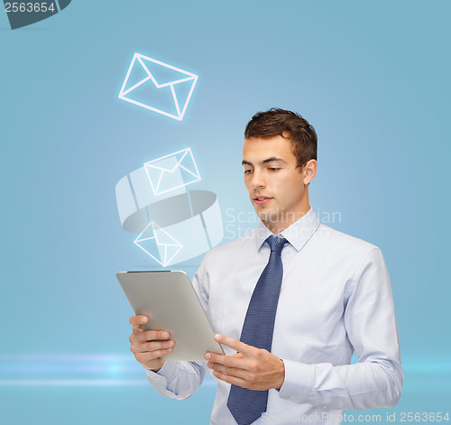 Image of buisnessman with tablet pc and envelope