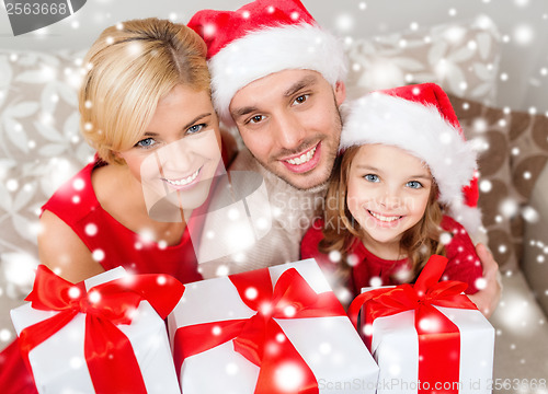 Image of smiling family holding many gift boxes