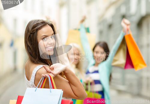 Image of beautiful woman with shopping bags in the ctiy