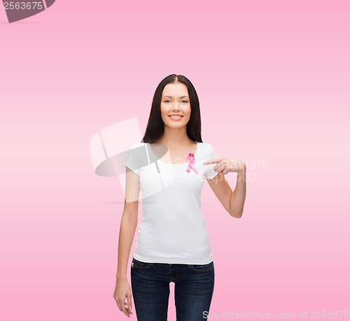 Image of smiling woman with pink cancer awareness ribbon