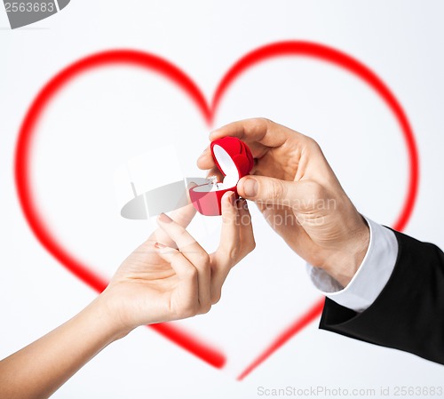 Image of couple hands with engagement ring