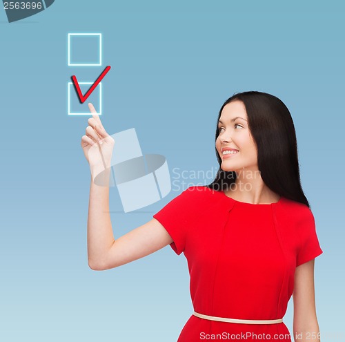 Image of young woman in red dress pointing her finger