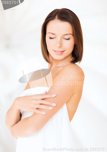 Image of beautiful woman standing in towel