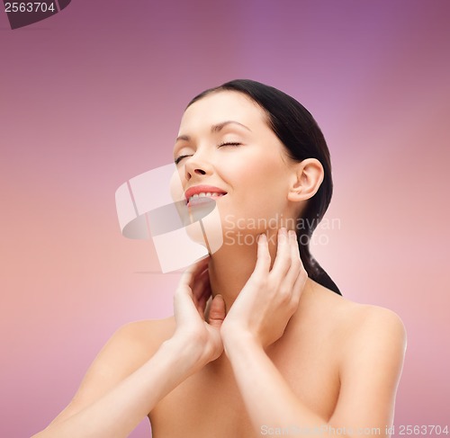 Image of smiling young woman with closed eyes