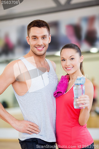 Image of two smiling people in the gym after class