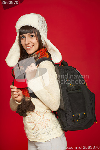 Image of Winter woman tourist holding credit card