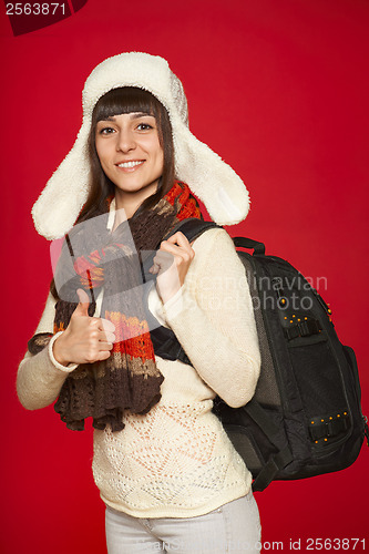 Image of Winter woman tourist with backpack
