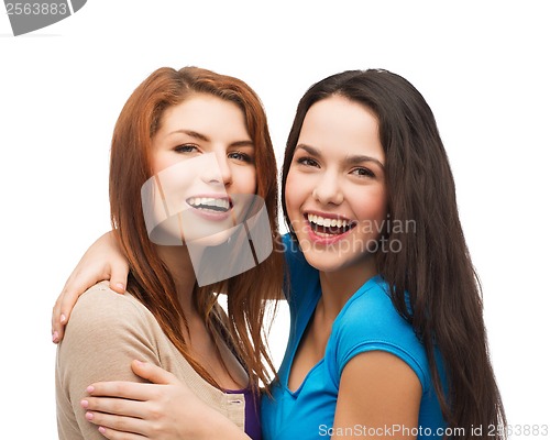 Image of two laughing girls hugging