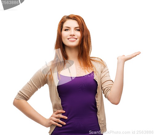Image of teenager holding something on the palm of her hand