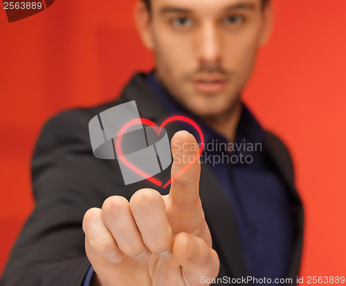 Image of handsome man in suit pressing virtual button