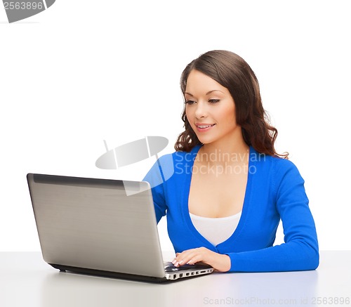 Image of smiling woman in blue clothes with laptop computer