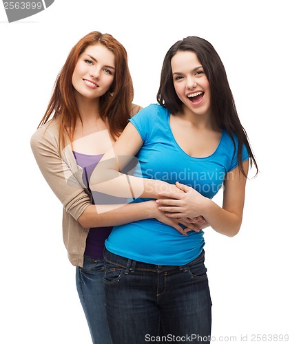 Image of two laughing girls hugging